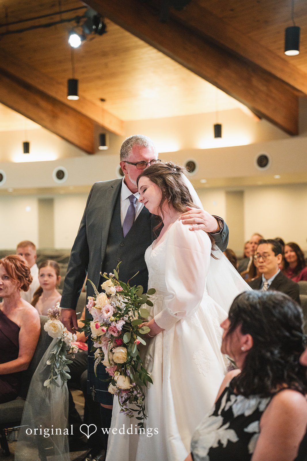 An emotional moment the bride's father kissed the bride