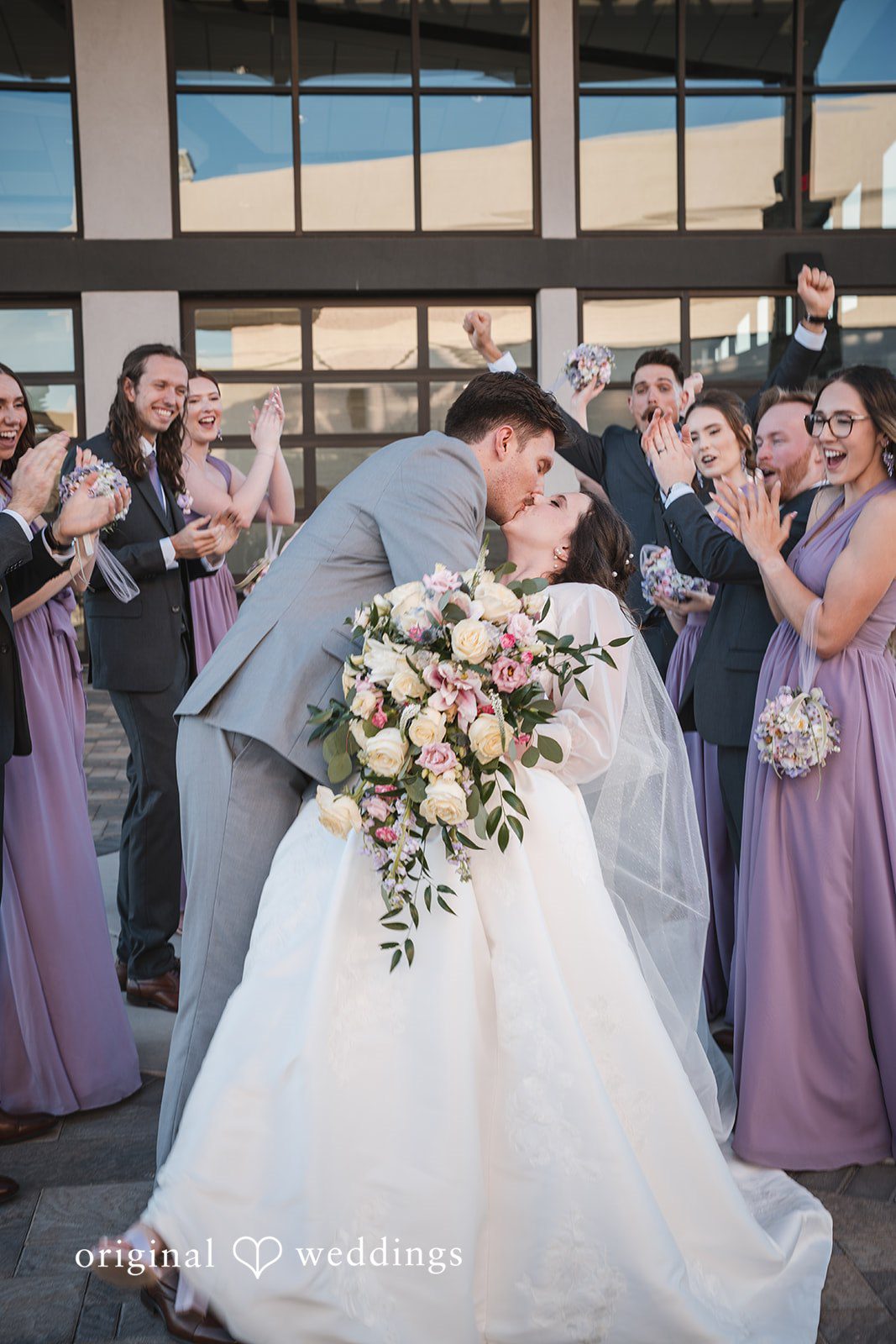 A romantic portrait of the couple with cheers from the bridal party