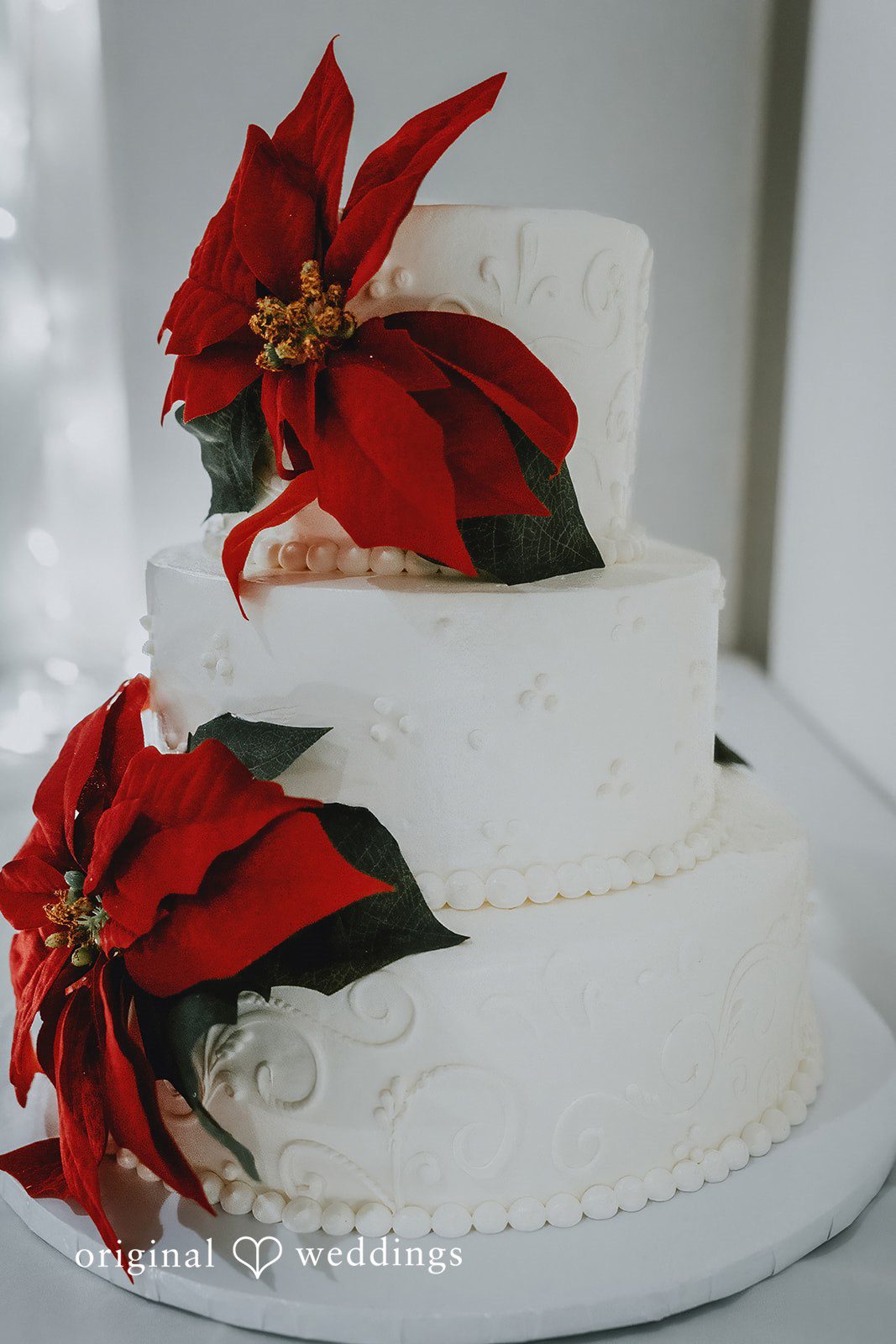 Claire + Richard An all-white wedding cake adorned with delicate florals