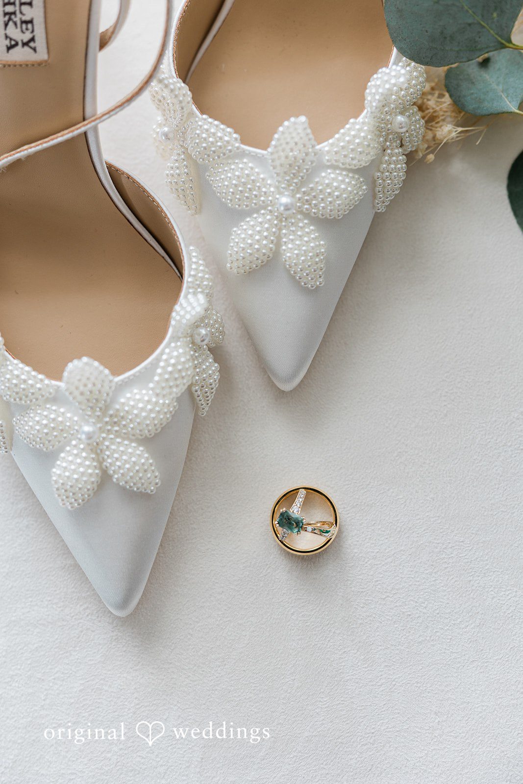 A detail shot of the bride's shoes and wedding ring
