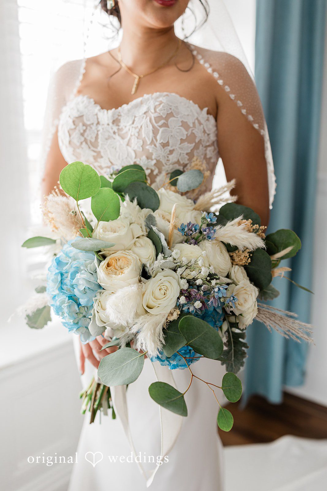 A close-up shot of the bride carrying her huge bouquet