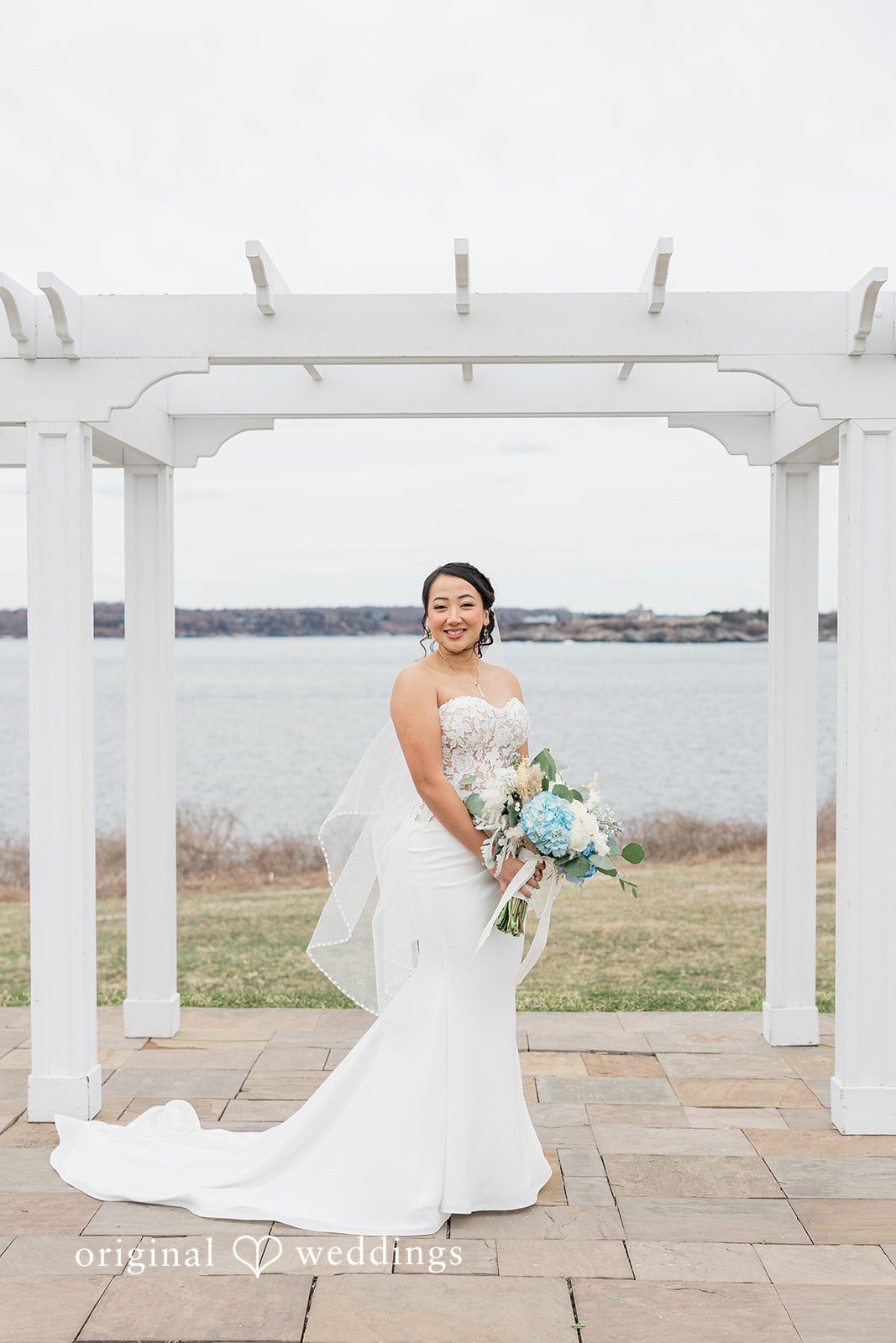 Our Providence wedding photographers captured a stunning portrait of the bride by the waterfront