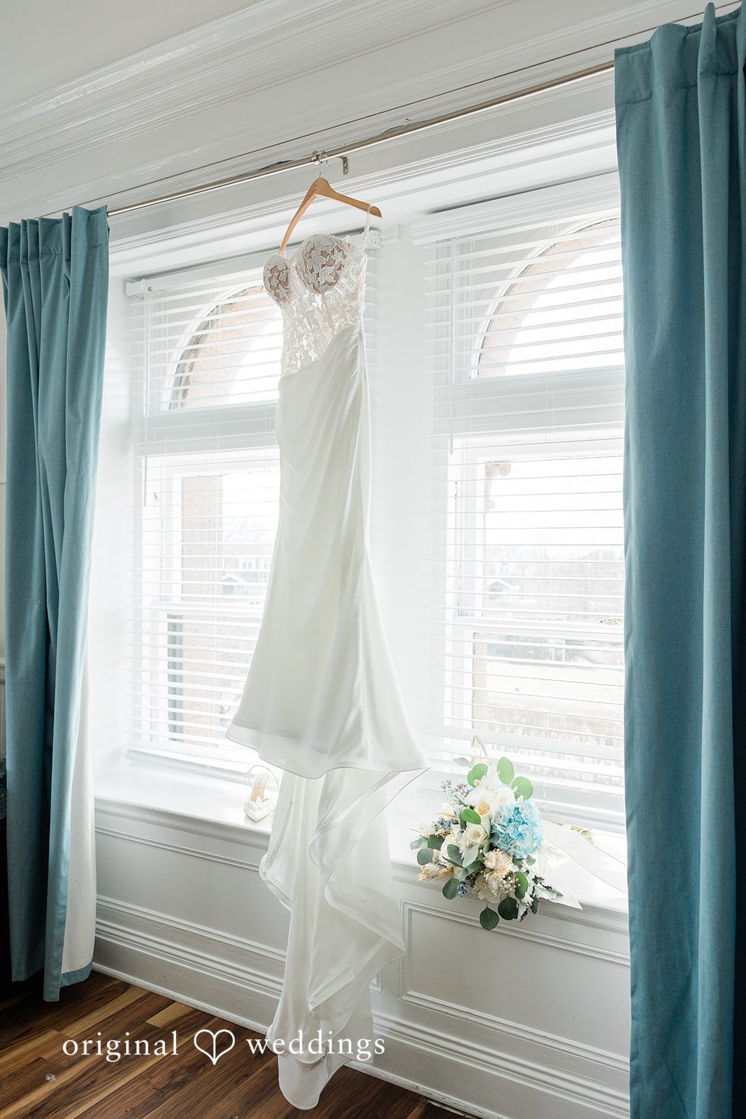 The bride's gown gracefully hanging at the bridal suite