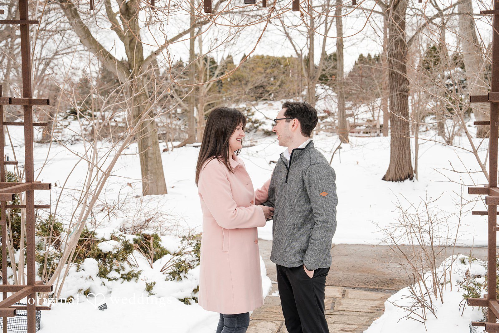 Couple sharing a joyful moment while laughing at Olbrich Gardens