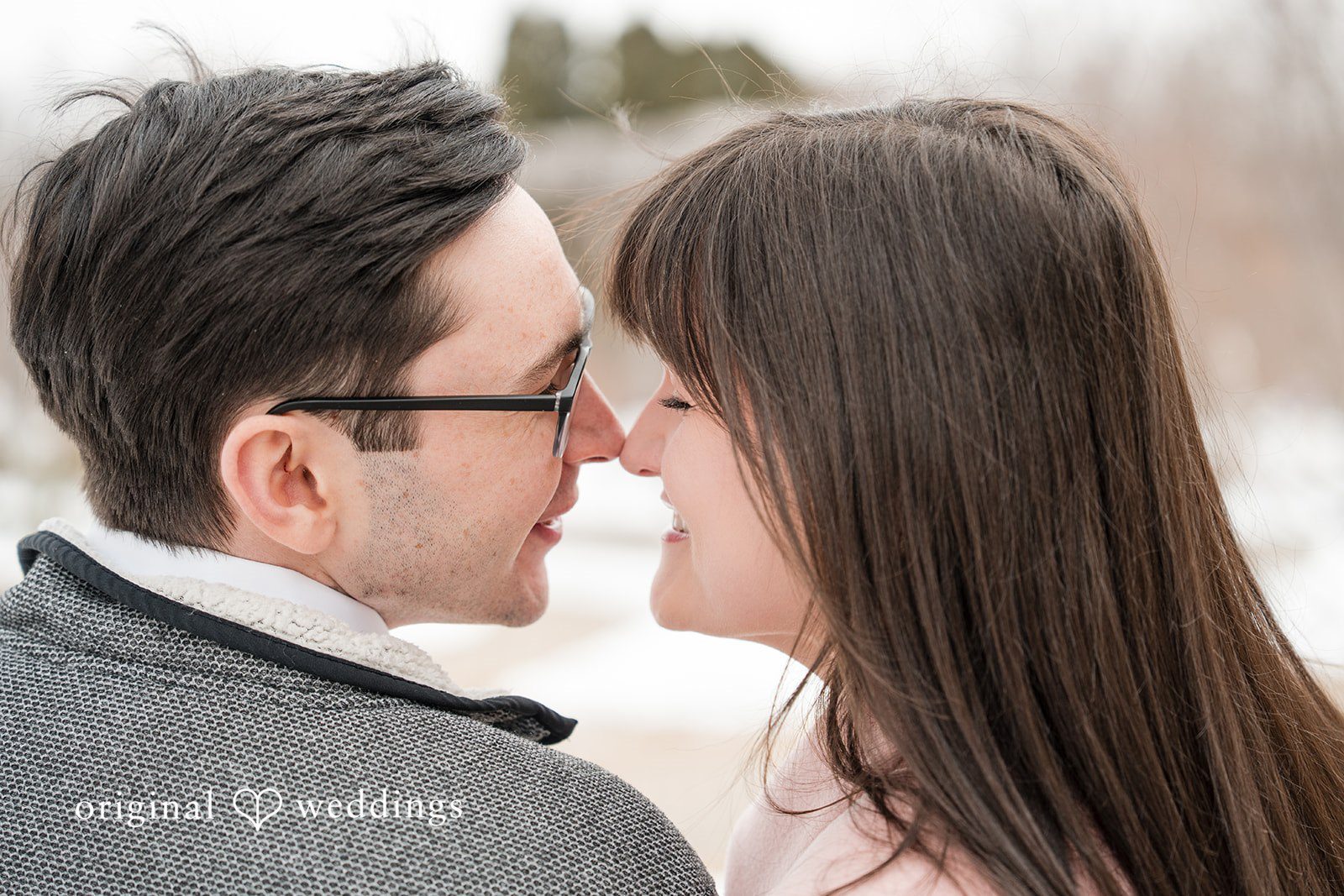 Engagement photography services by Original Weddings capturing a romantic close-up moment of the couple at Olbrich Gardens