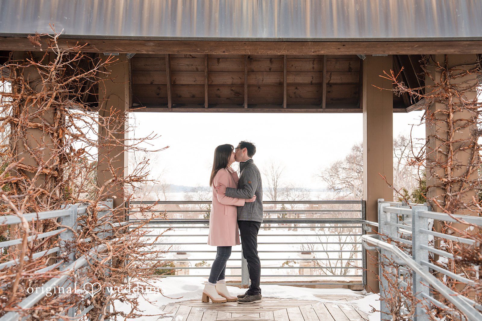Couple sharing a kiss under a beautiful gazebo at Olbrich Gardens