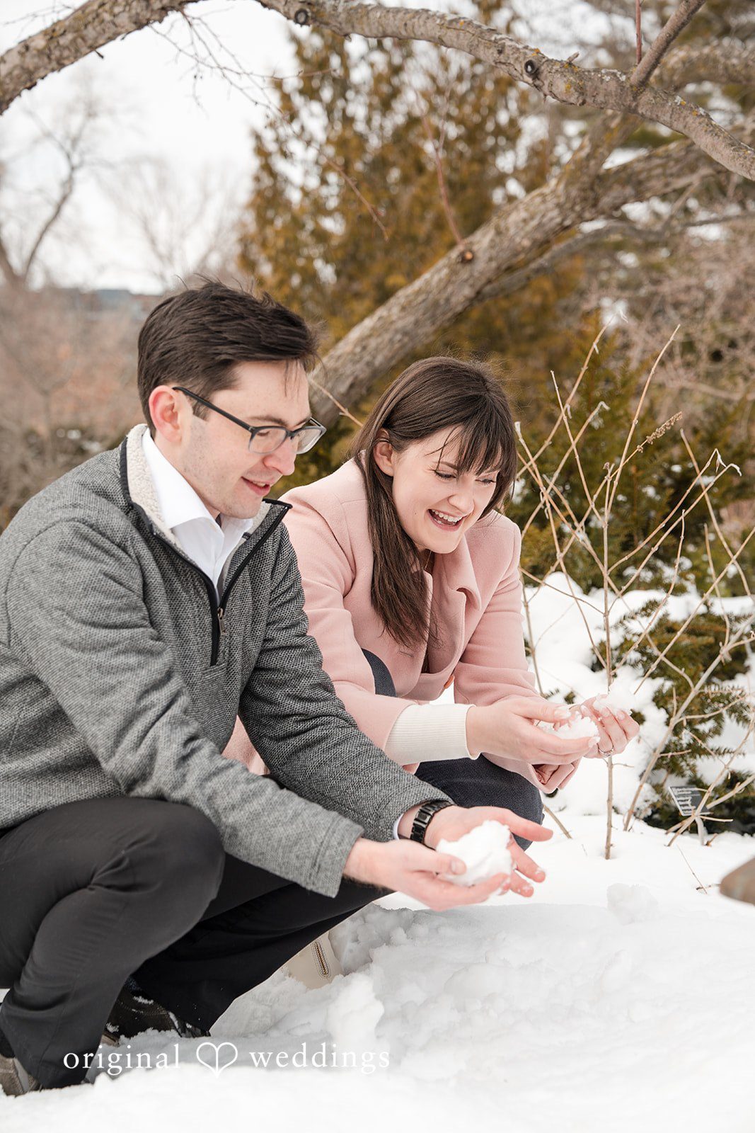 Couple laughing and playing with snow together