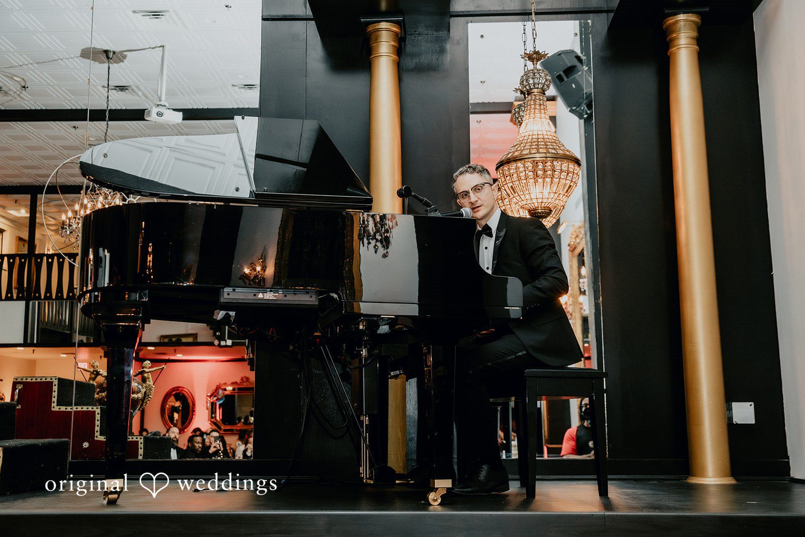 Groom playing piano during the celebration
