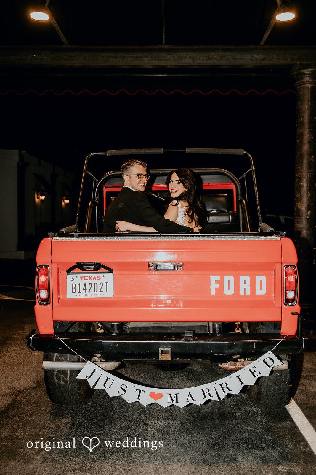 Bride and groom departing in a getaway car