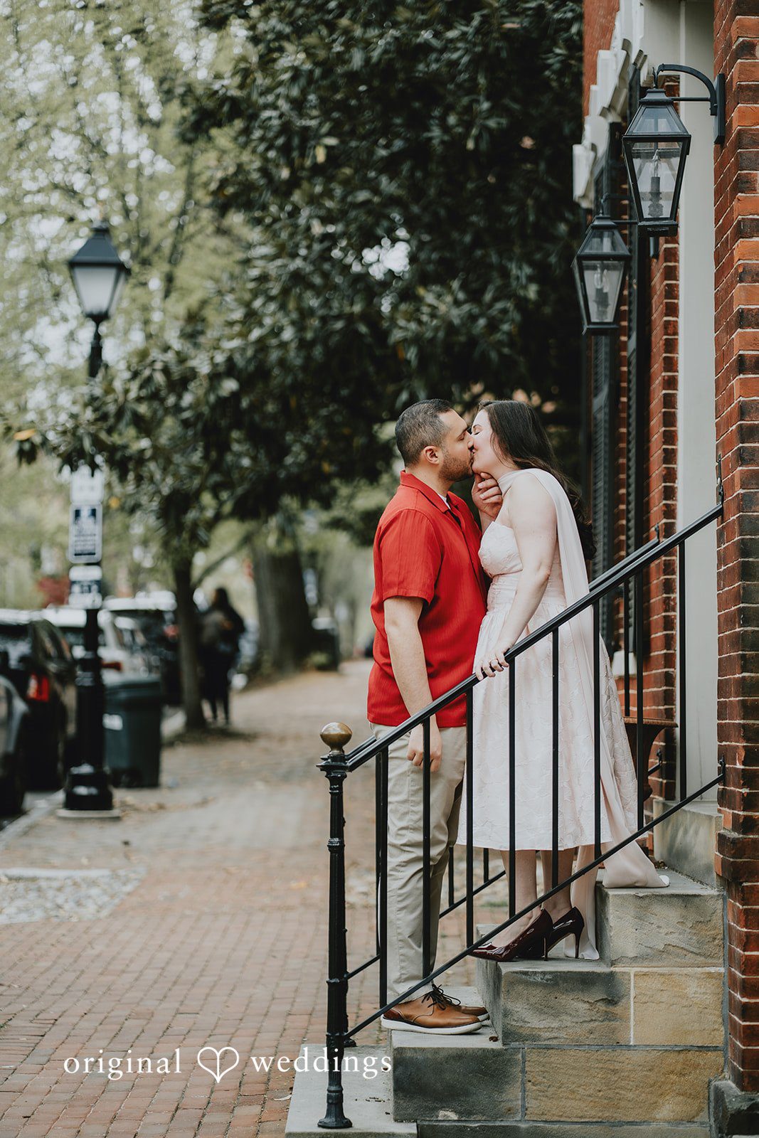 Lucy + Francesco The couple shares a romantic kiss on the stairs