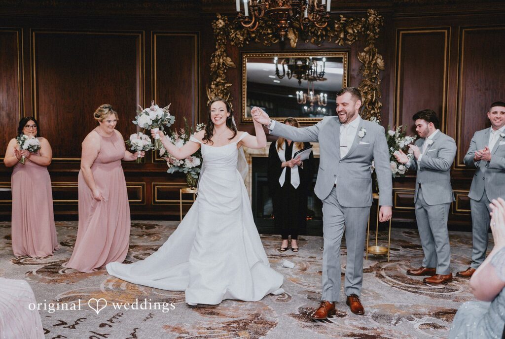 Brooklynn + Adam Boston wedding photographers capturing bride and groom smiling with raised hands at Omni Parker House by Original Weddings