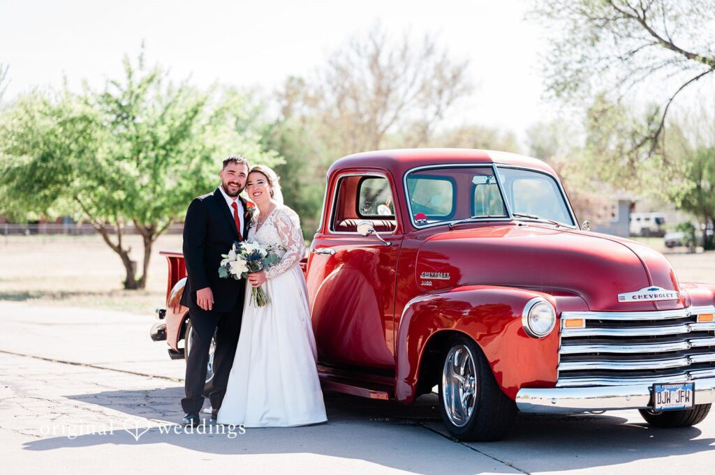 Christina + Quinton Our Denver wedding photographers at Original Weddings captured a stunning portrait of the couple beside their car at Our Lady of Guadalupe Catholic Church