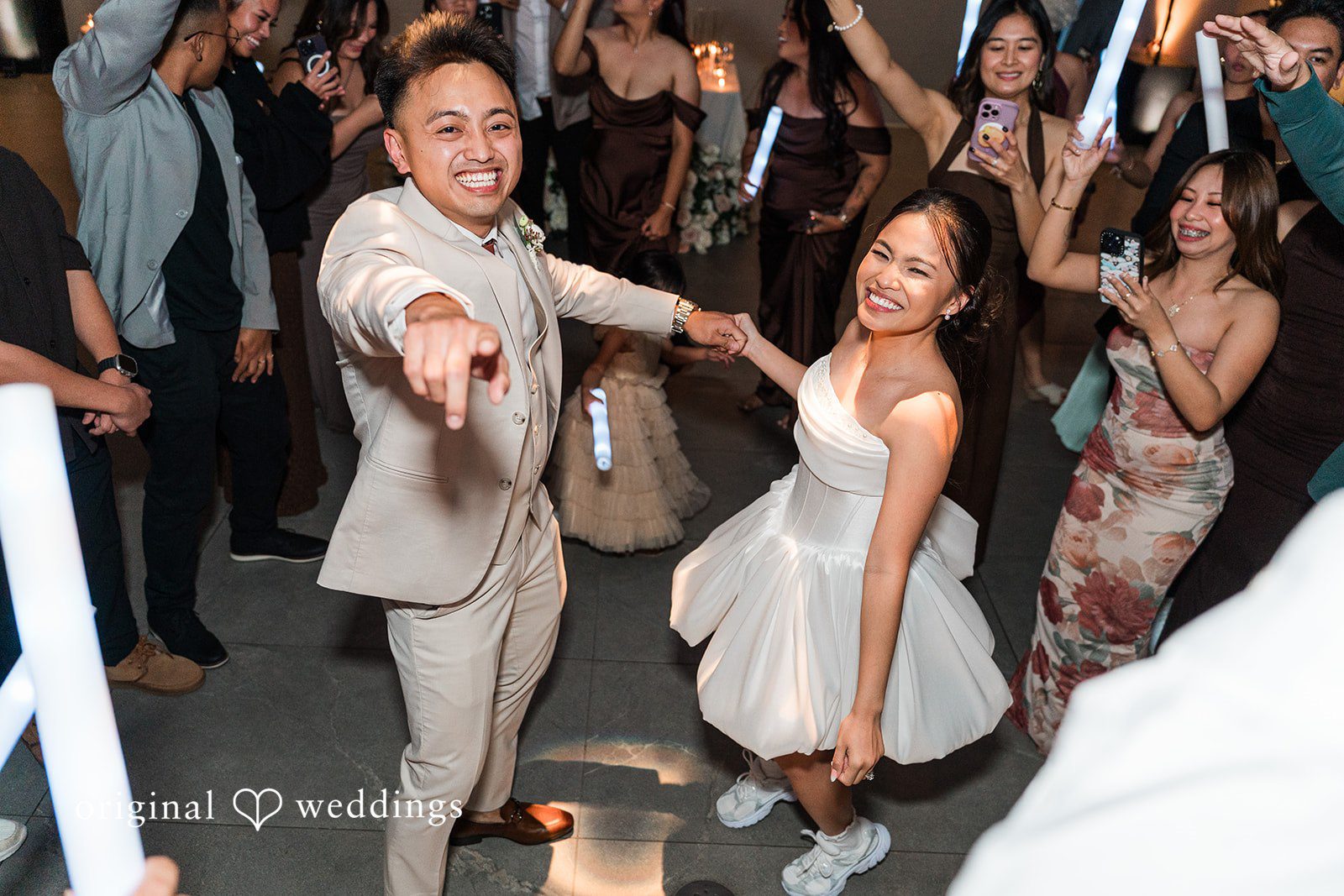 Charize Giann + Mark Shou Bride and groom dancing with guests at Palm Event Center