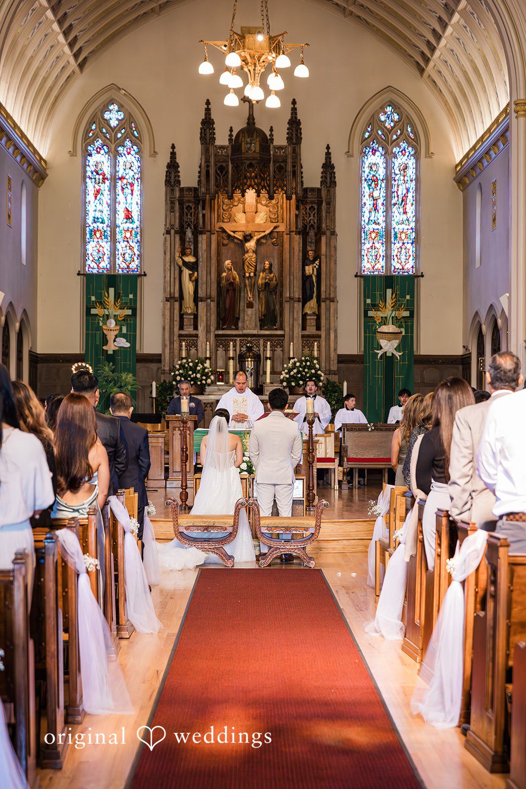 Charize Giann + Mark Shou Elegant church wedding ceremony with bride and groom standing at the altar surrounded by family and guests