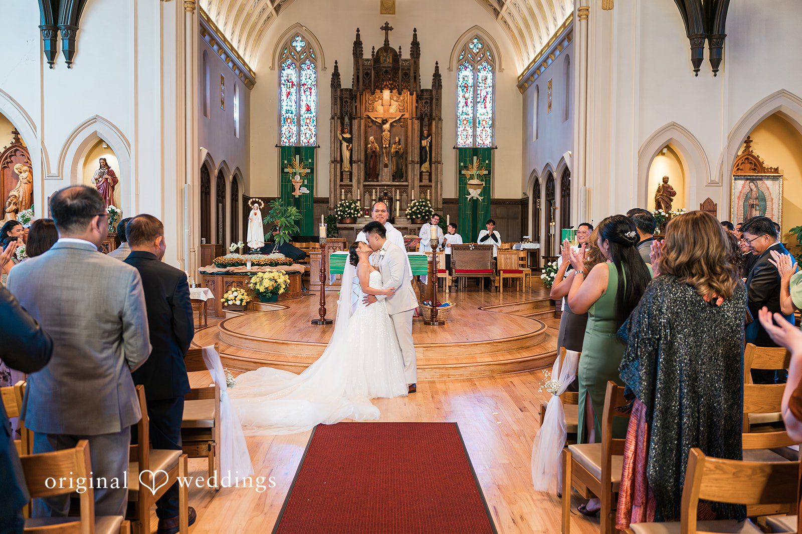 Charize Giann + Mark Shou Romantic moment of bride and groom kissing after wedding ceremony at Palm Event Center