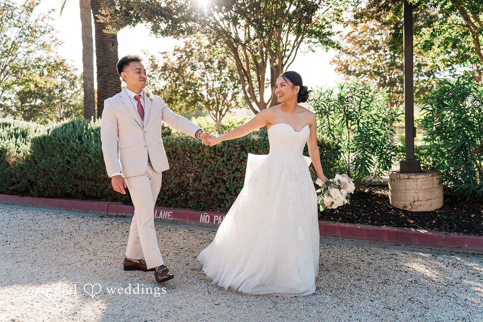 Charize Giann + Mark Shou Bride and groom walking together through elegant outdoor venue at Palm Event Center