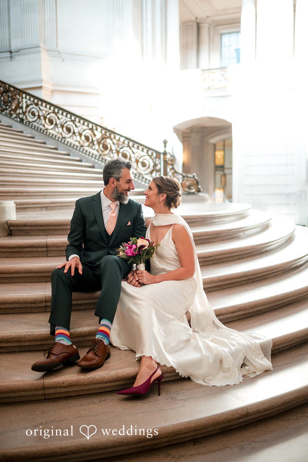 A romantic portrait of the couple on the stairs of the City Hall