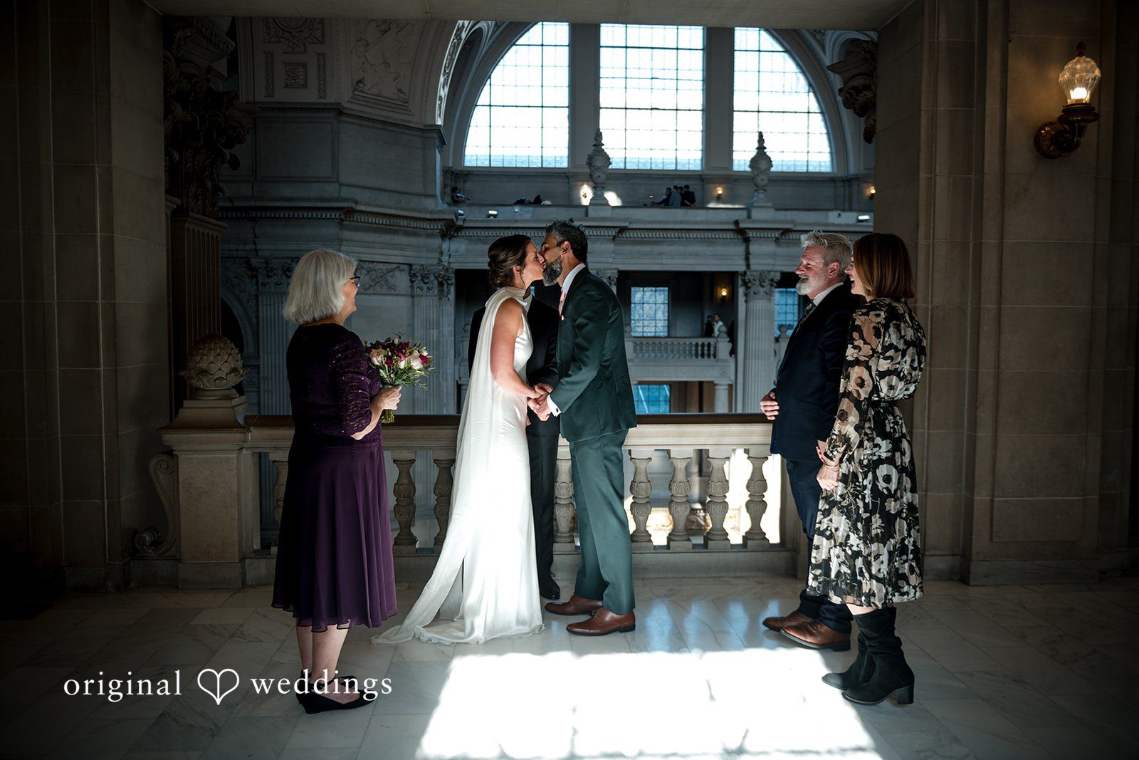 The couple seals their union with a kiss