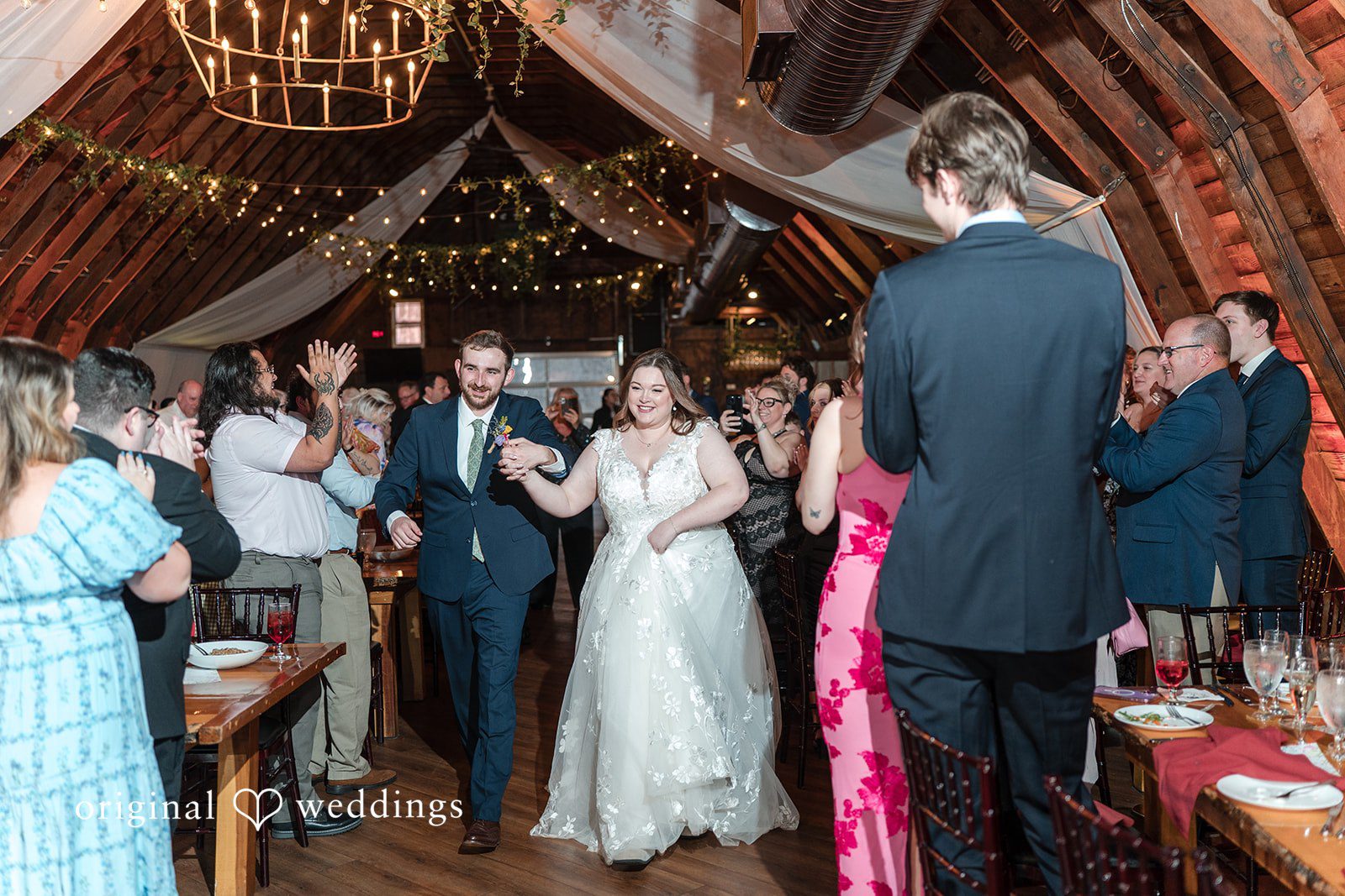 Newlyweds entering wedding reception at Perona Farms