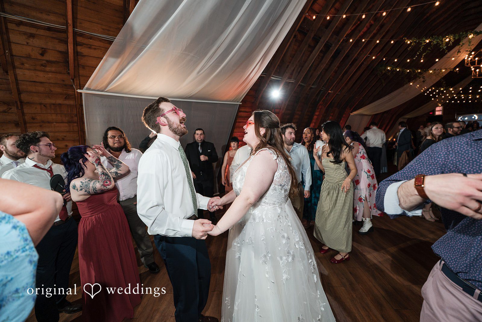 Bride and groom celebrating on dance floor at Perona Farms