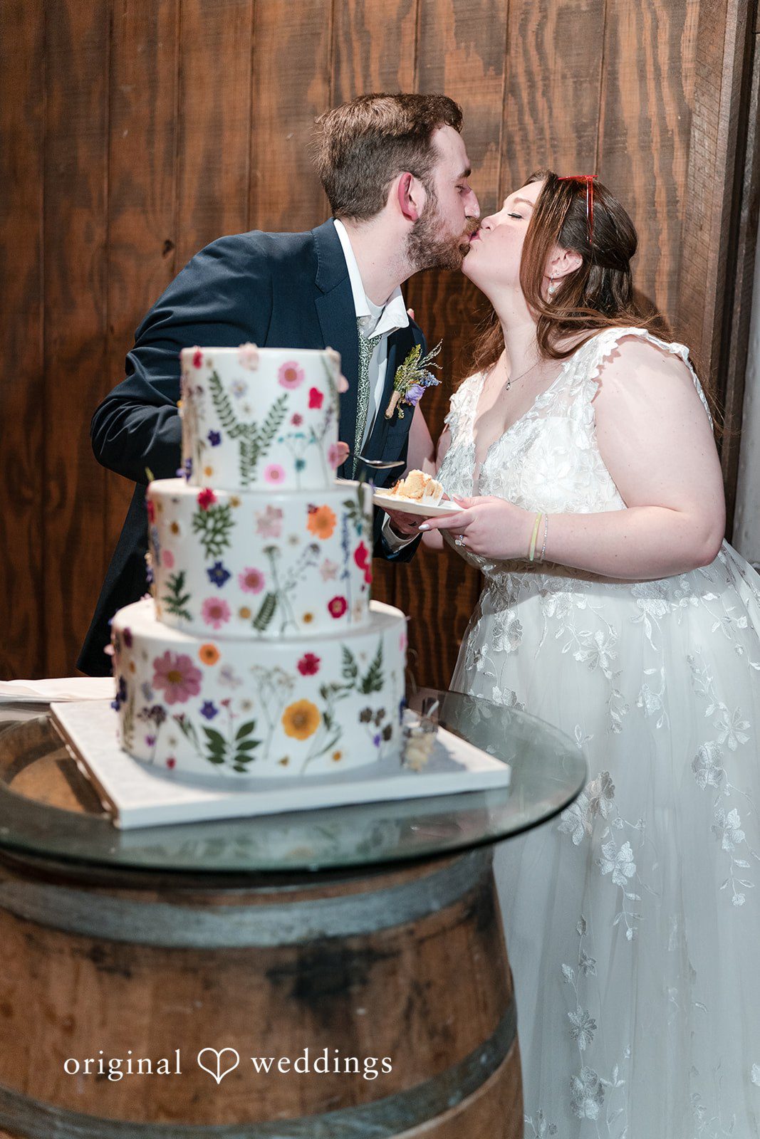 Romantic newlywed kiss at Perona Farms reception
