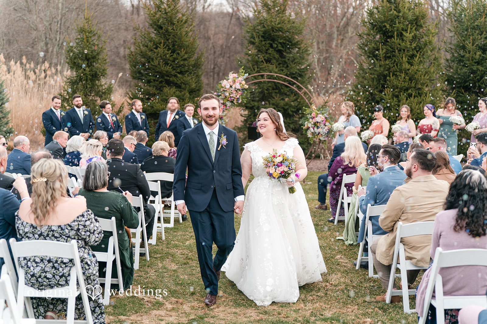 Newlyweds walking down the aisle at Perona Farms