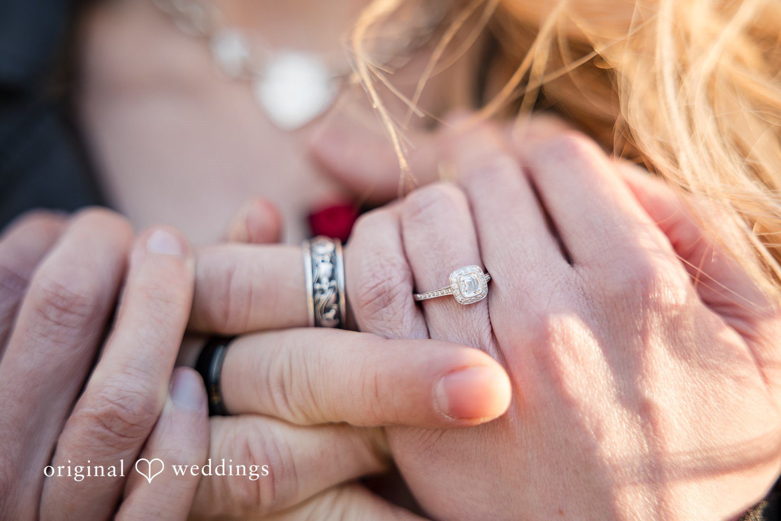 Candid shot of engagement rings by original weddings