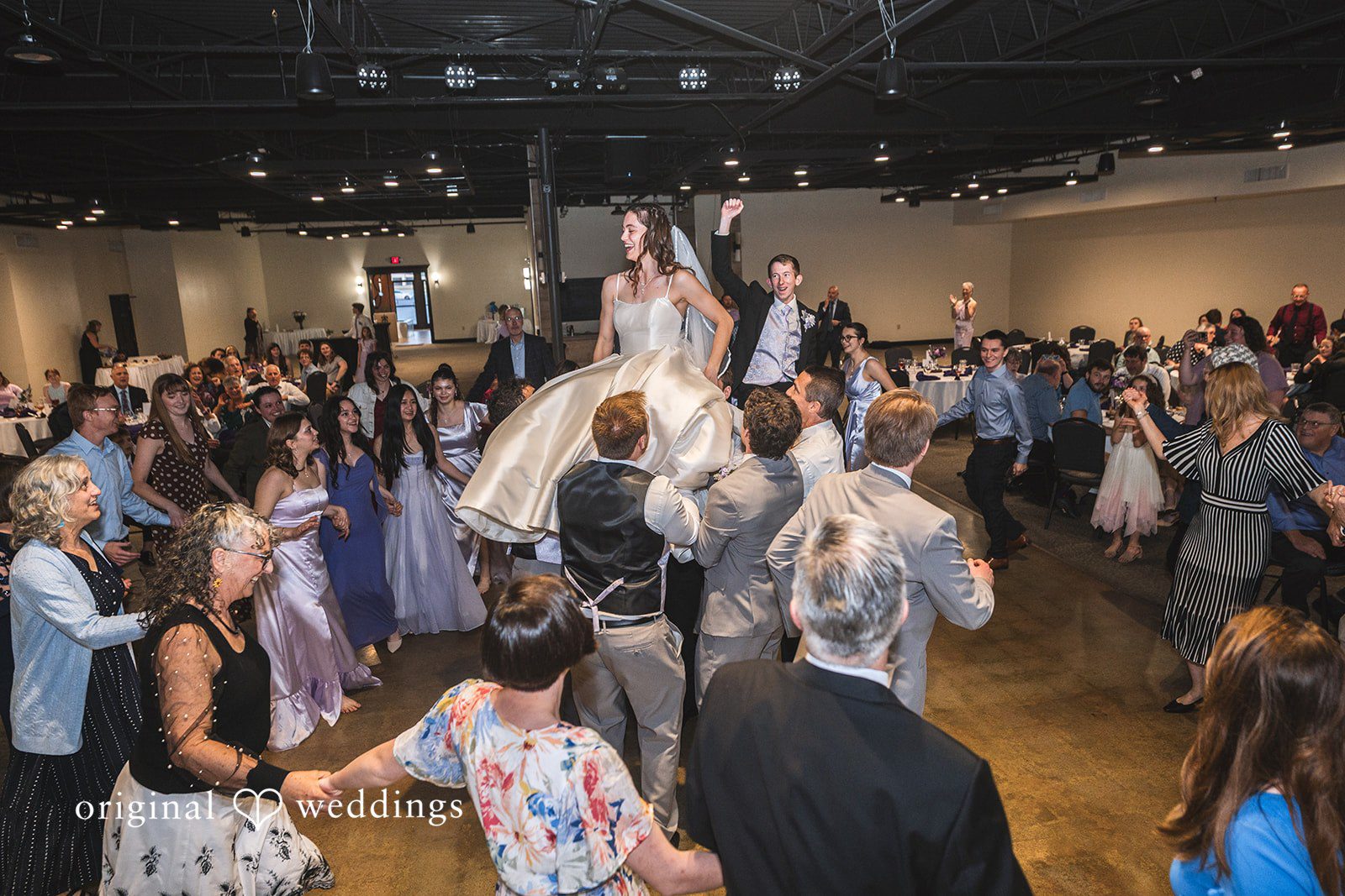 Samantha + Ryan Bride and groom lifted on friends’ shoulders during the reception party