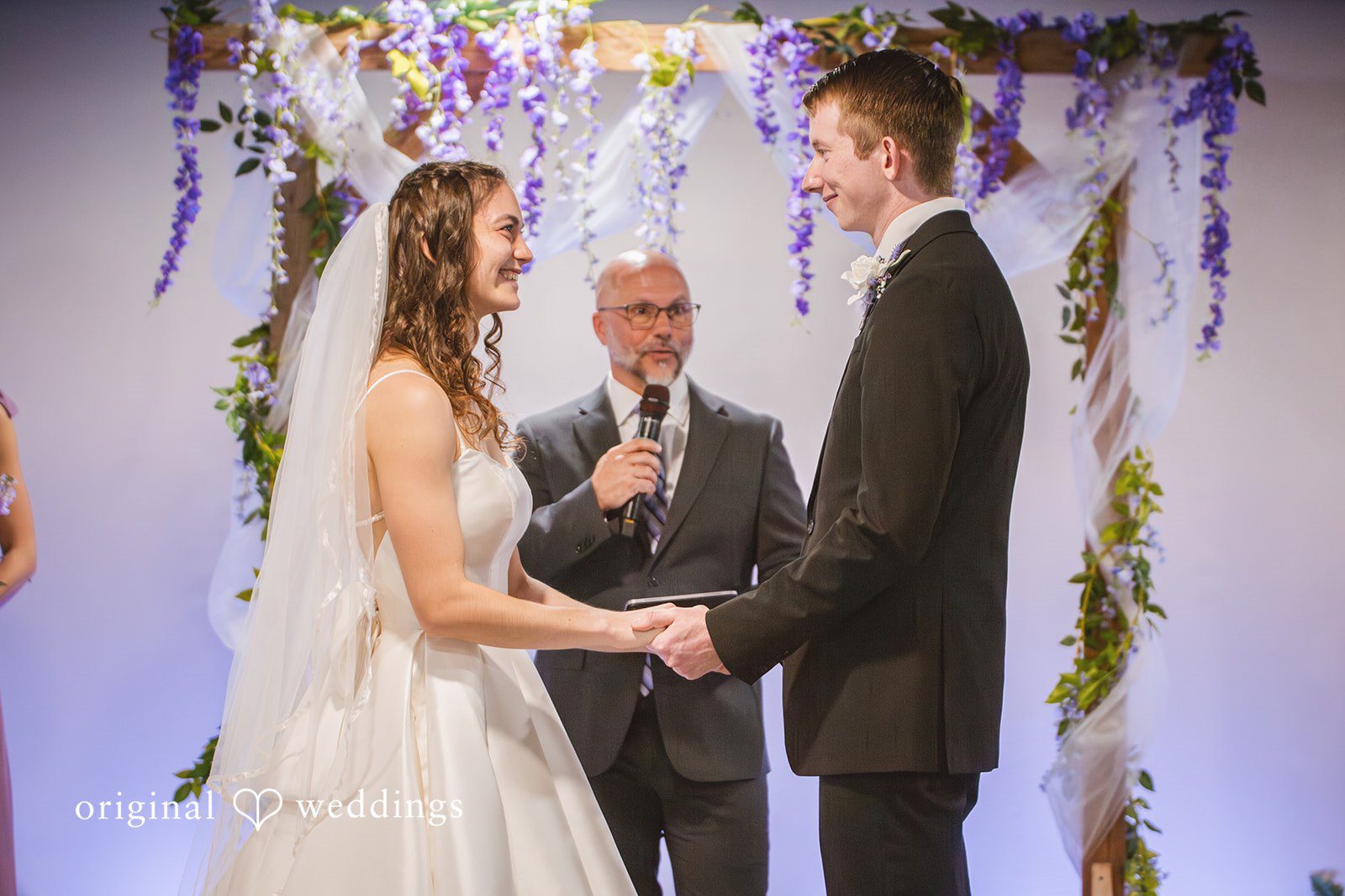 Samantha + Ryan Bride and groom holding hands while exchanging vows