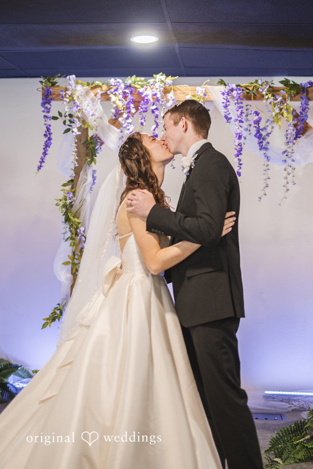 Samantha + Ryan Bride and groom sharing their first kiss after exchanging vows