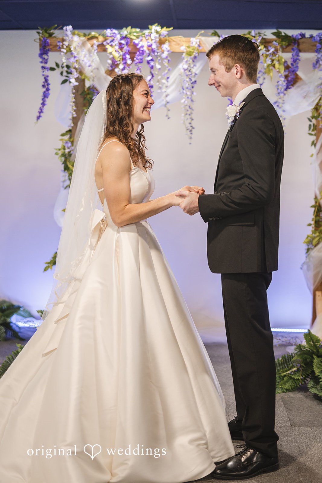 Samantha + Ryan Newlyweds holding hands together at the ceremony site