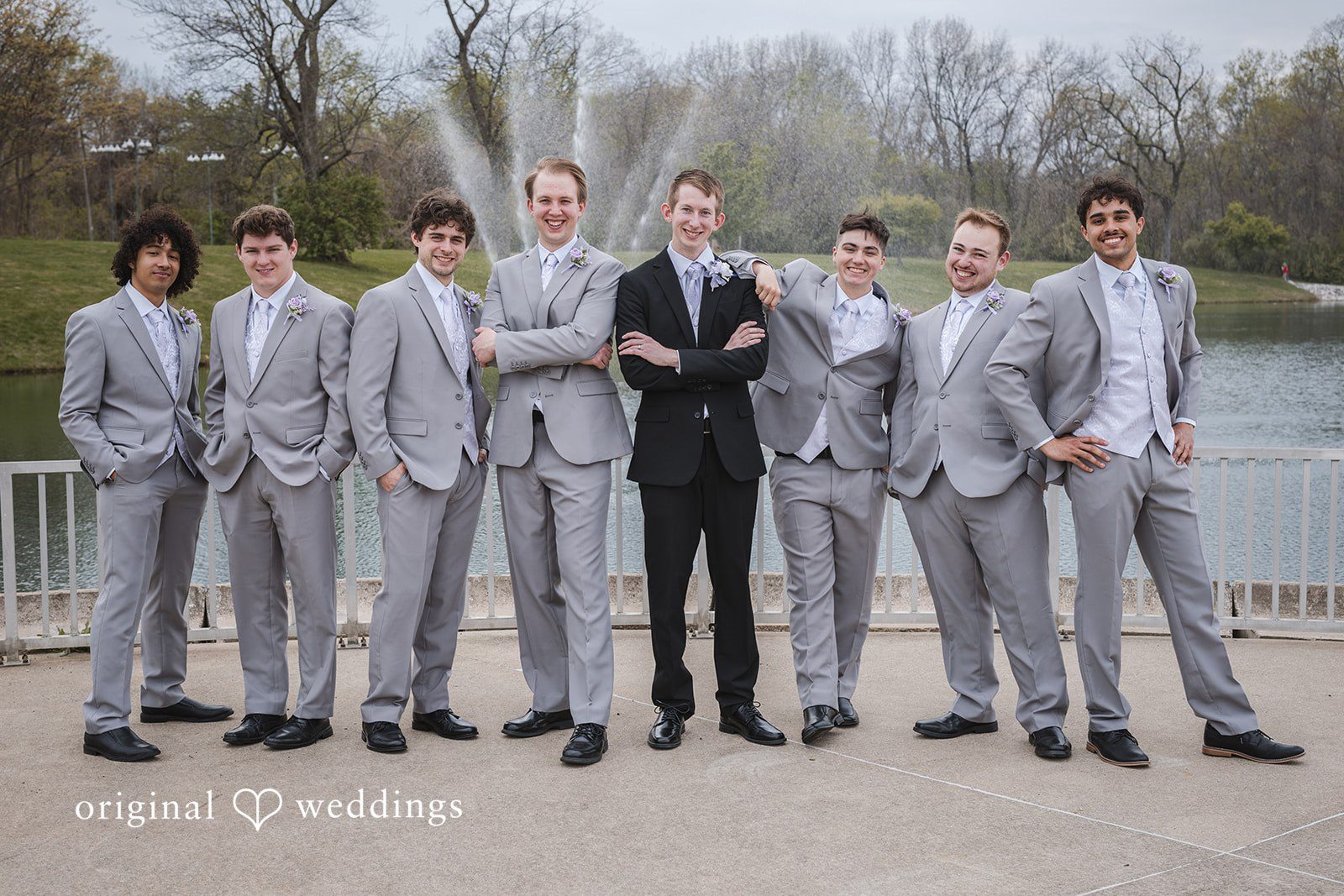 Samantha + Ryan Groom posing with groomsmen outside the venue