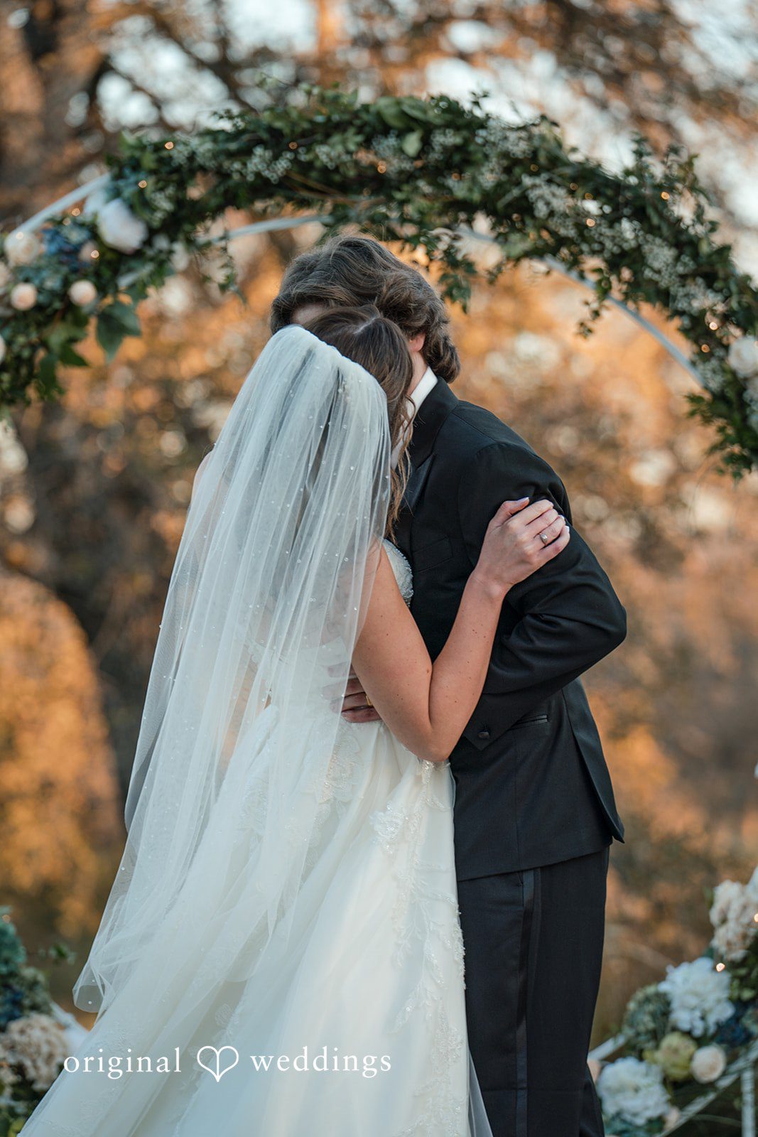 Romantic bride and groom kiss portrait at River Highlands Ranch