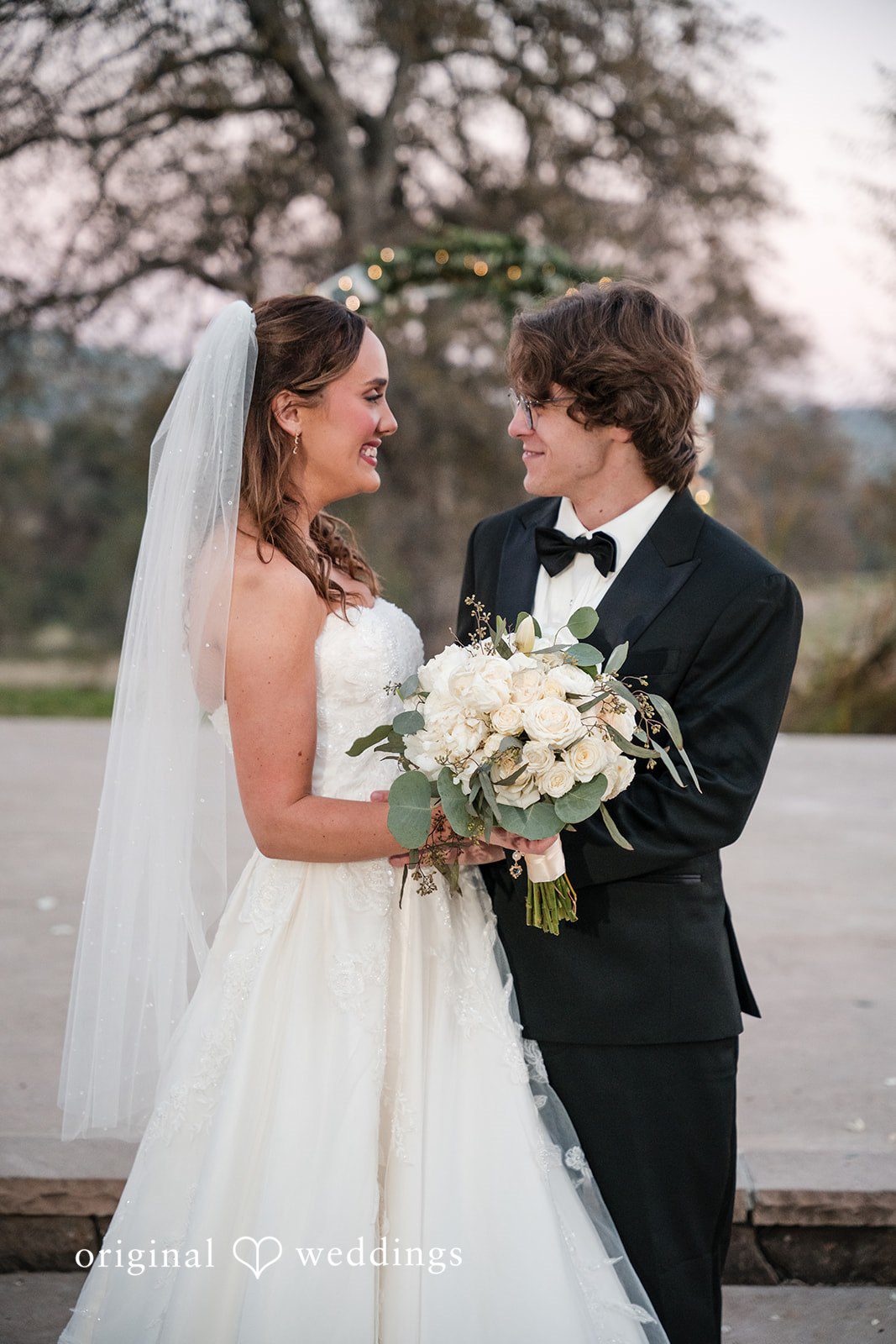 Romantic bride and groom close portrait while looking at each other at River Highlands Ranch