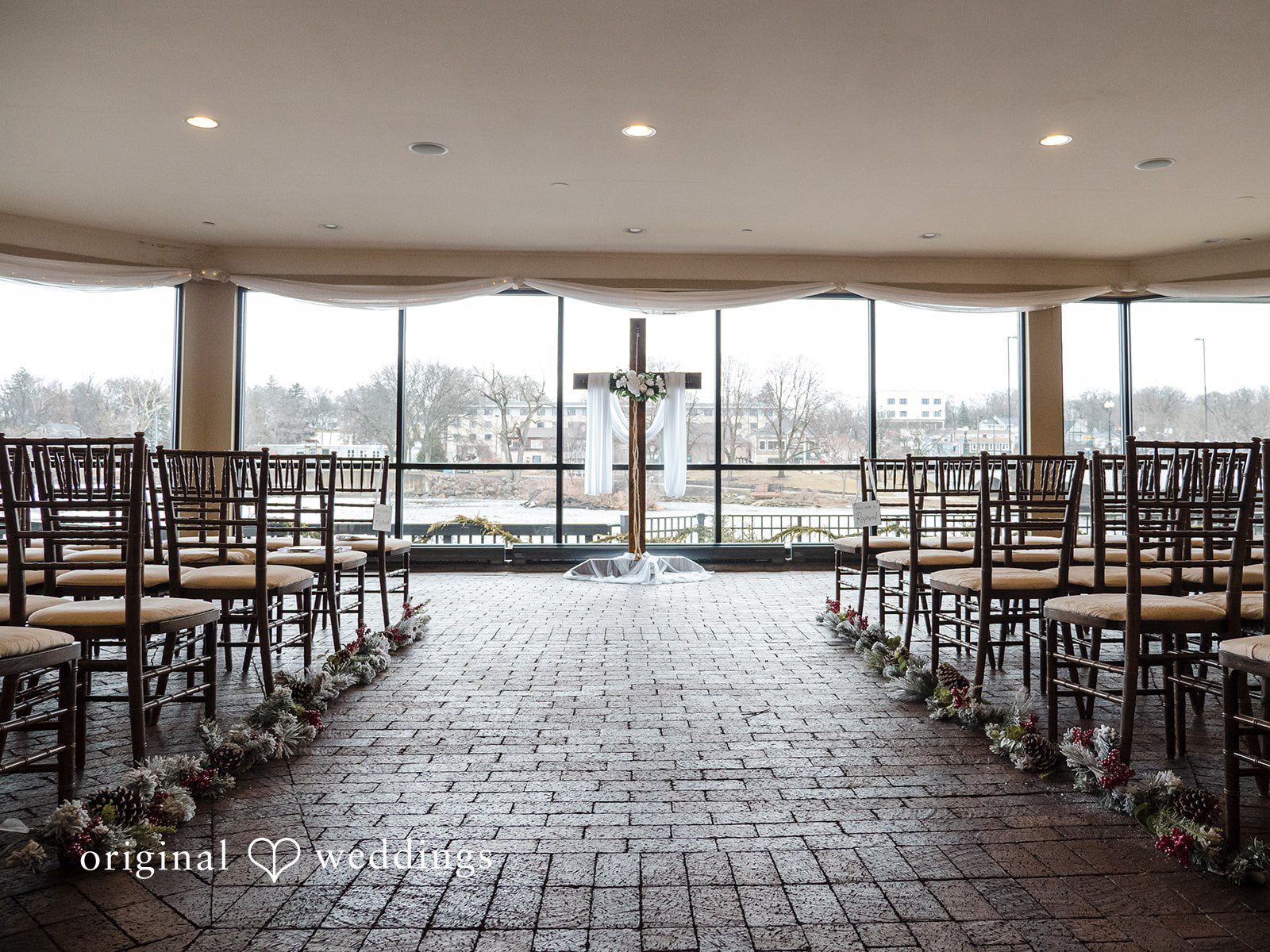 Indoor ceremony setup overlooking the water at Riverside Receptions
