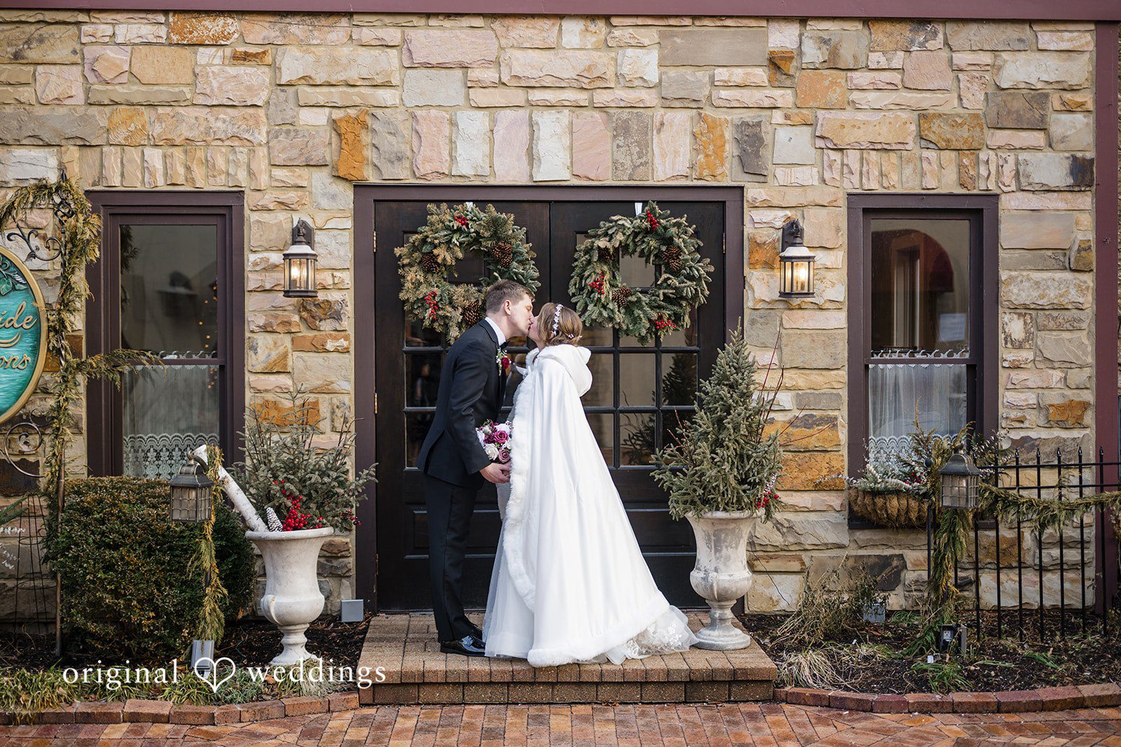 Bride and groom portrait at the entrance of the venue