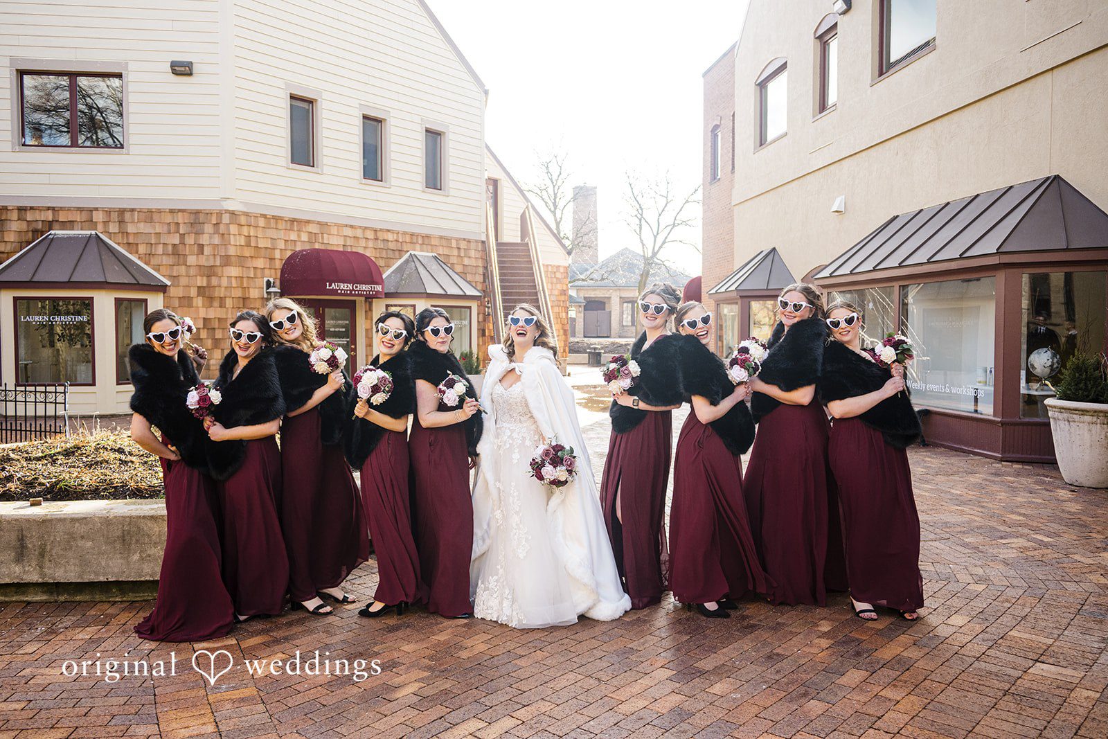 Bridesmaids group portrait outdoors in burgundy dresses