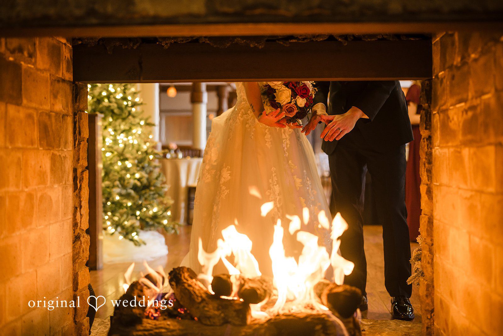 Romantic fireplace portrait of Amanda & Dylan at Riverside Receptions
