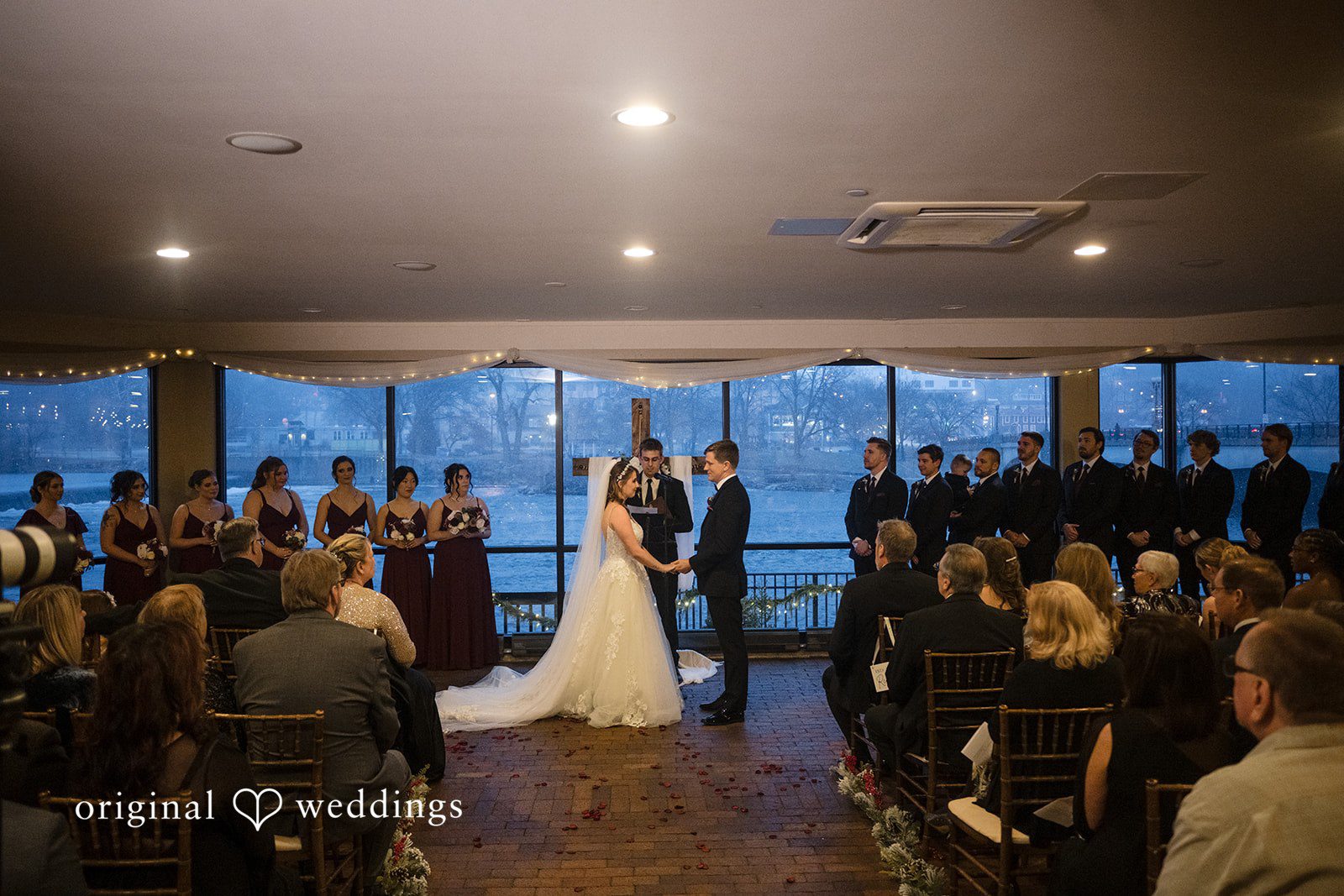 Indoor wedding ceremony at Riverside Receptions with waterfront views