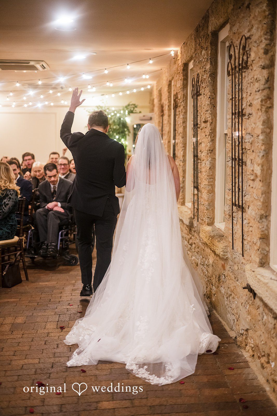 Bride and groom walking into the reception celebration together