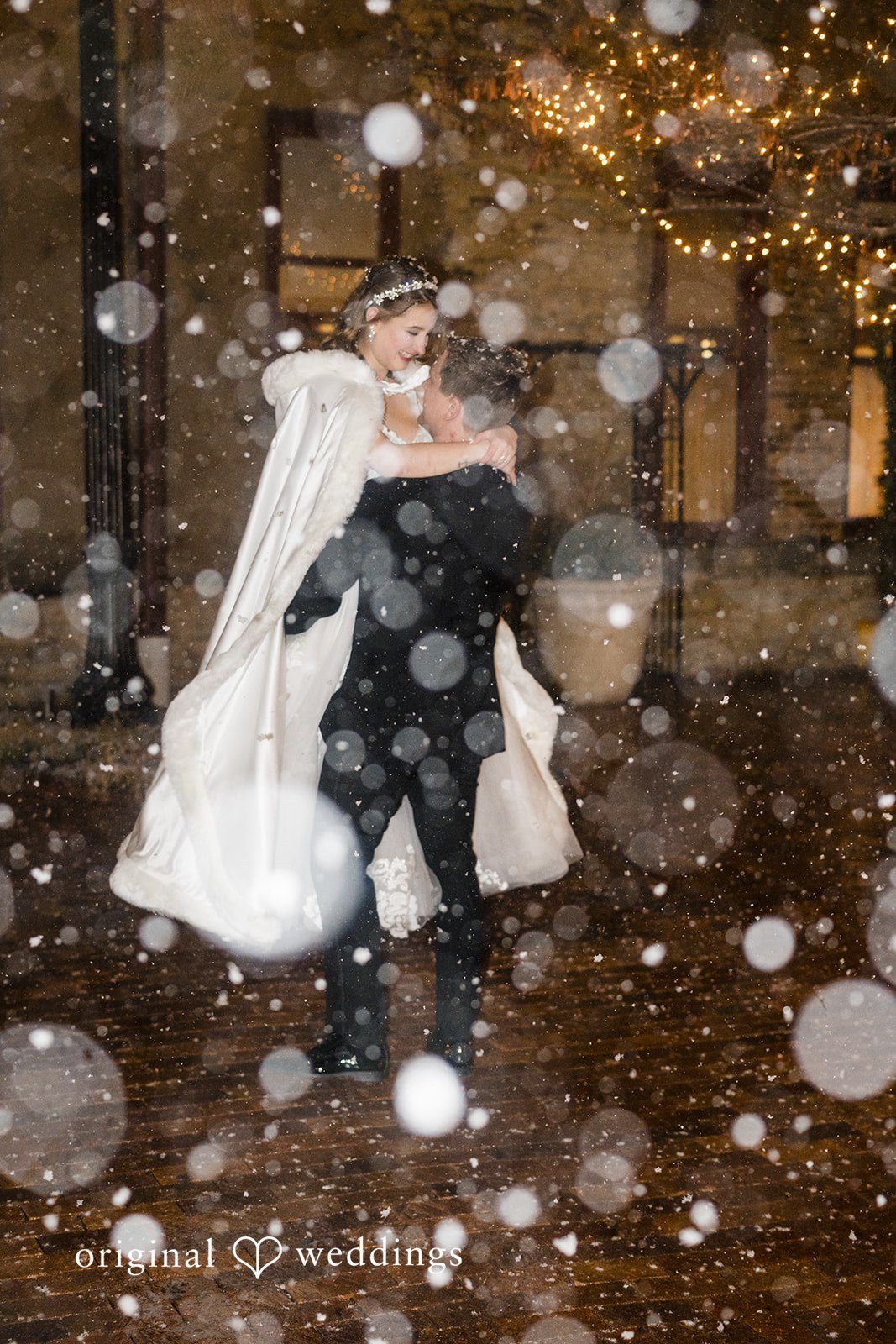 Snowy winter wedding portrait of the couple outdoors