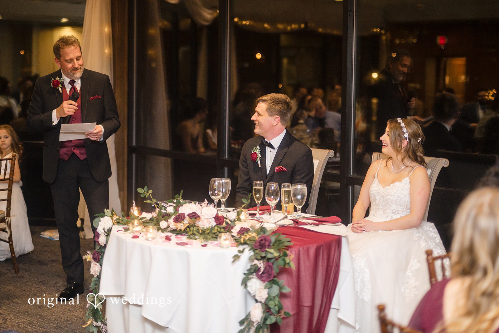 Reception speech moment with bride and groom seated together