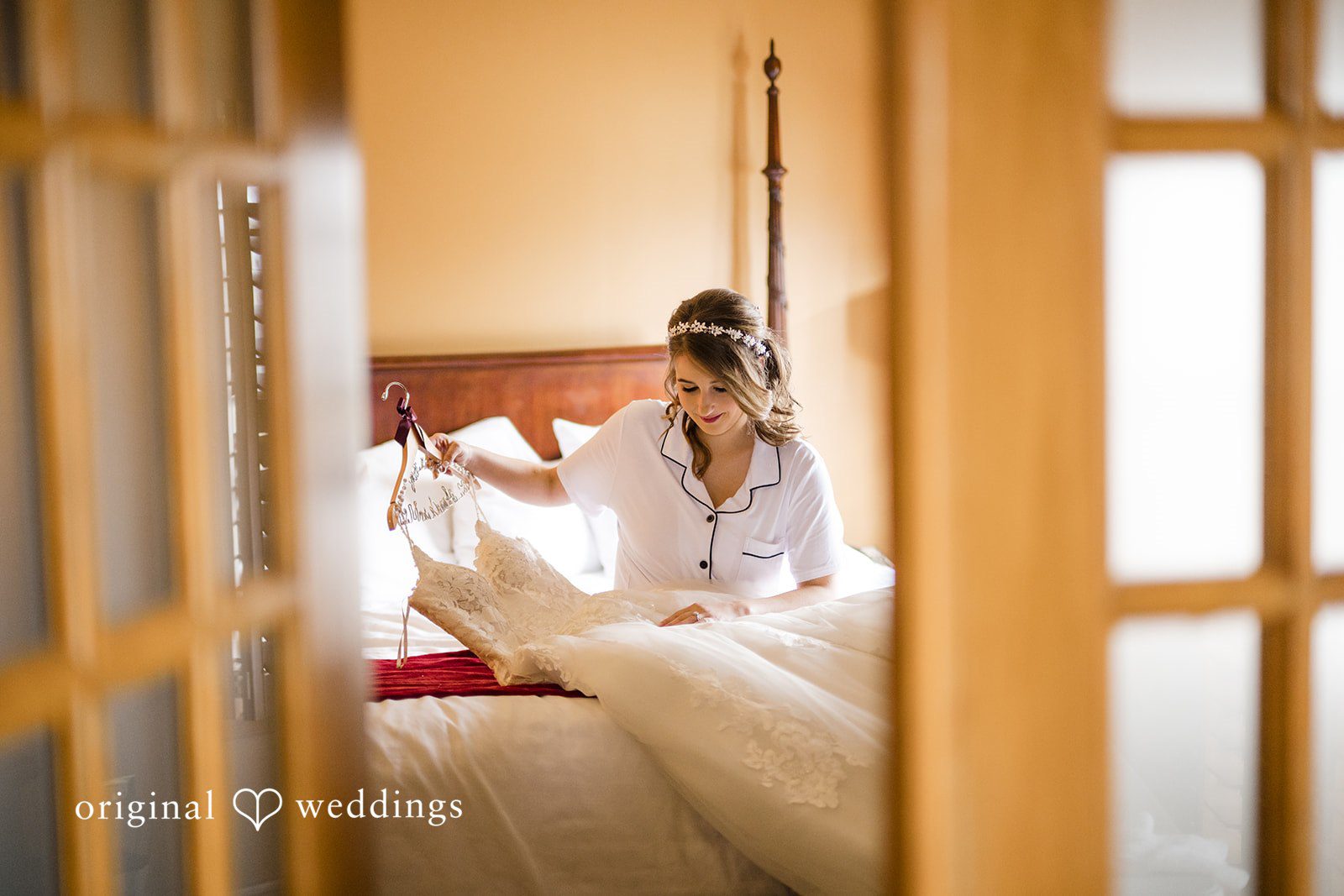 Bride sitting by the window in her wedding dress