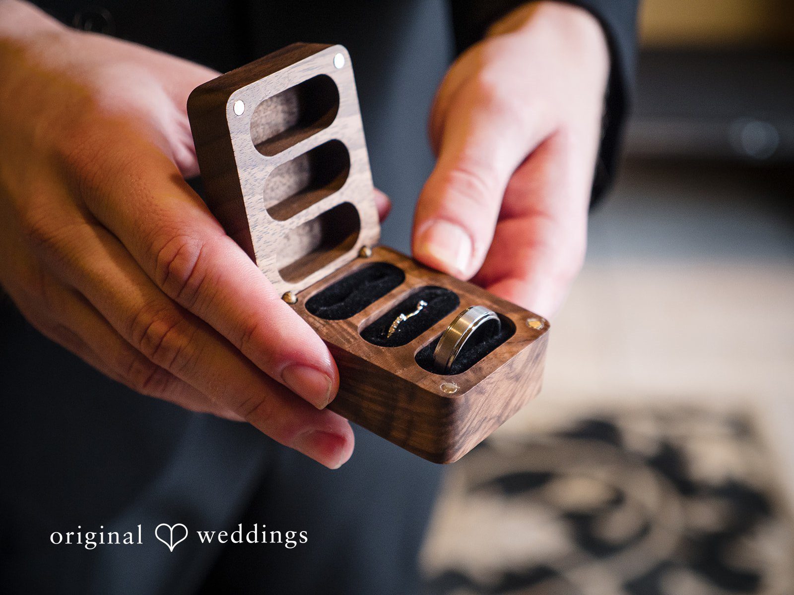 Close-up detail shot of wedding rings in a wooden ring box
