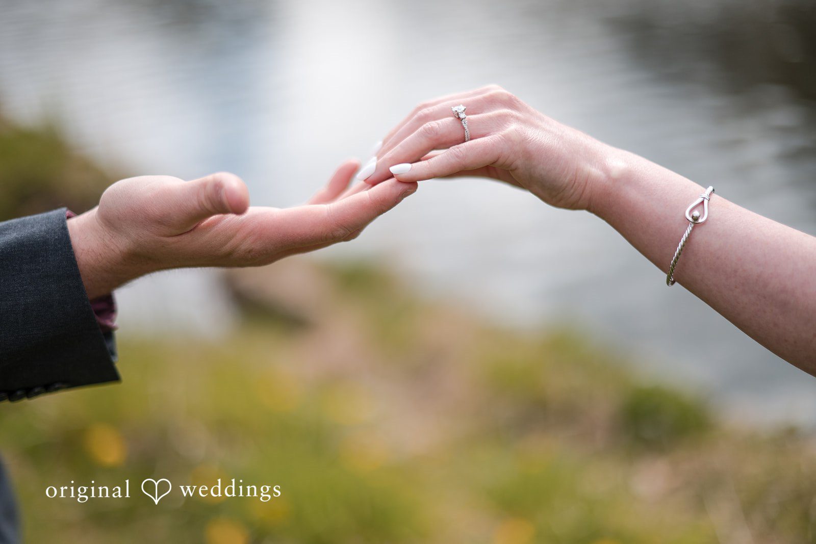 Close-up of engagement ring on couple’s hands at Roger Williams Park
