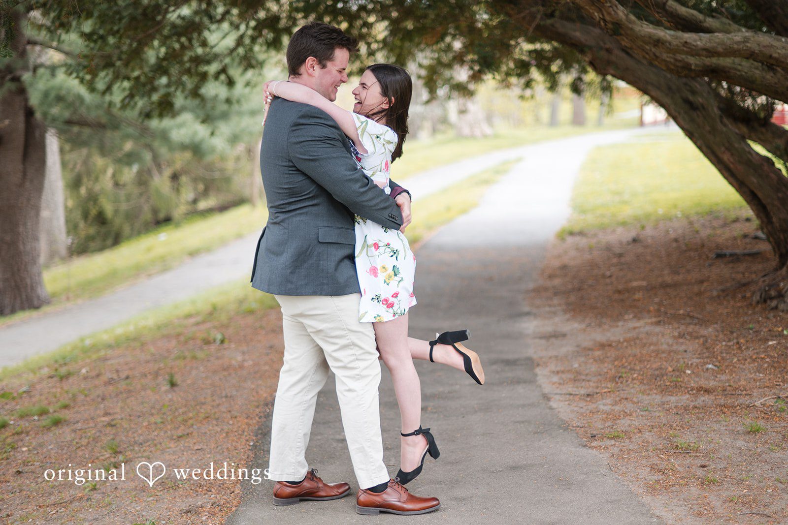 Romantic groom lifting bride at Roger Williams Park