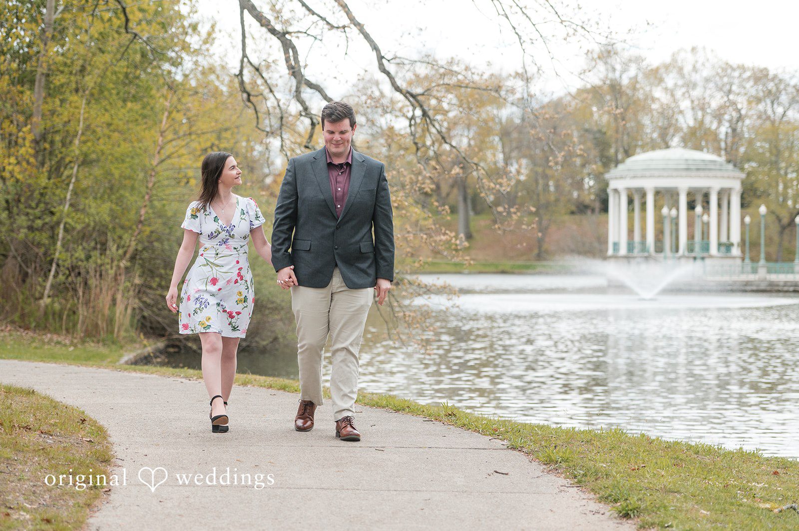 Engagement Photography Services capturing couple holding hands while walking  at Roger Williams Park by Original Weddings