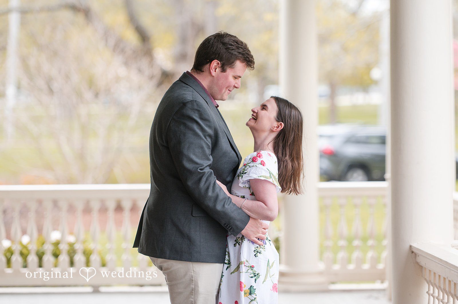 Couple hugging while smiling and looking at each other at Roger Williams Park