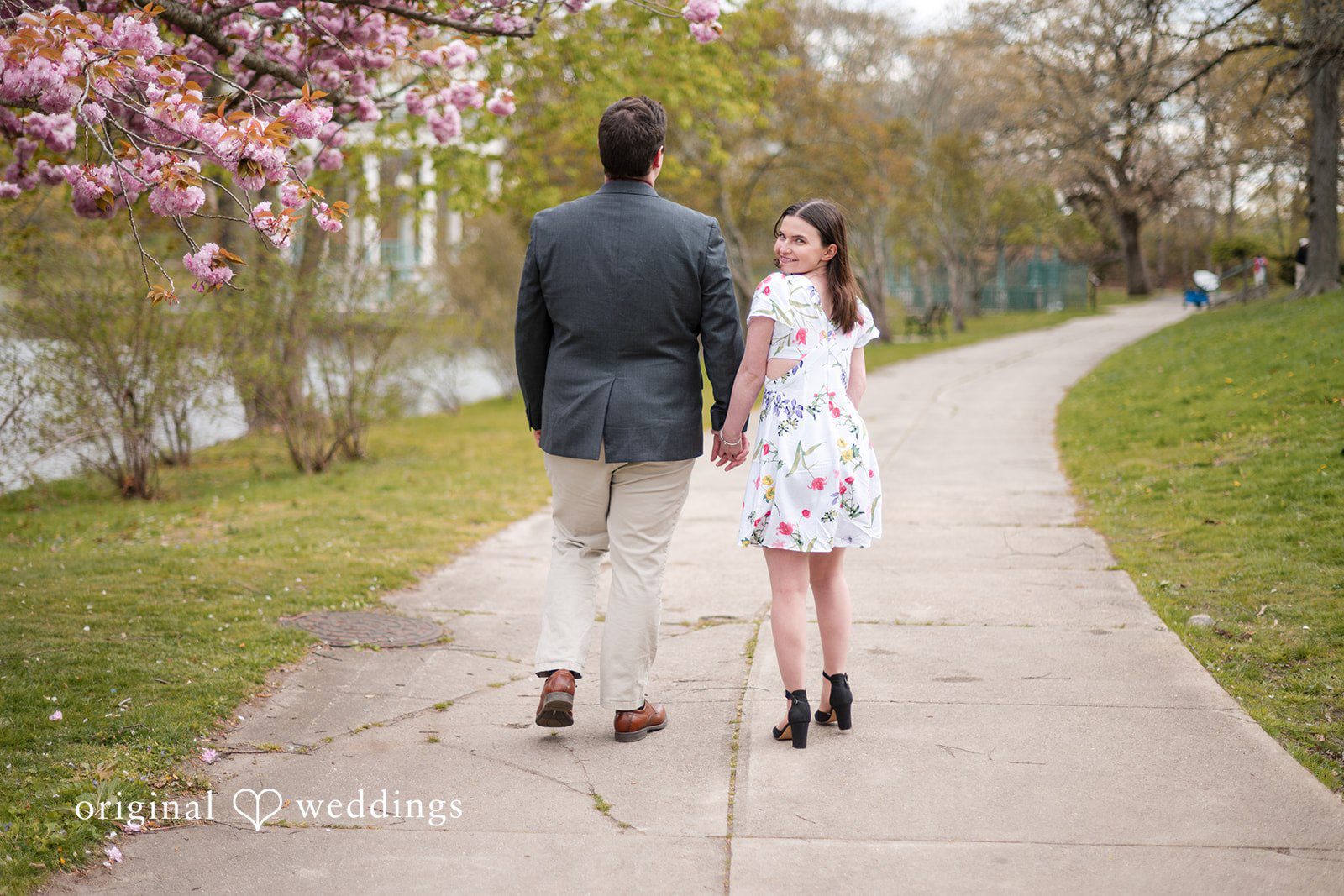 Couple walking with bride looking back at Roger Williams Park
