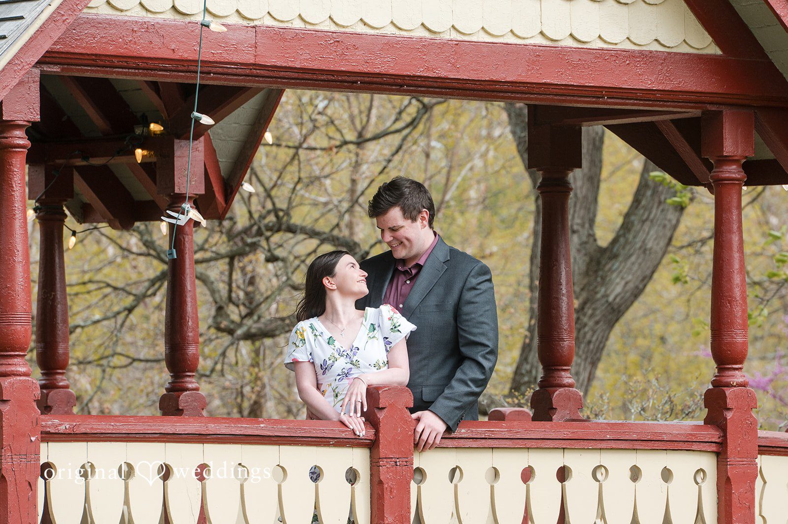 Engaged couple sharing a look while smiling at Roger Williams Park